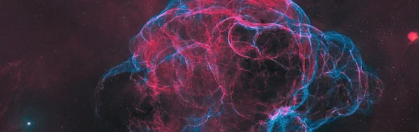 Wide-field image of the faint red and blue filaments of the Spaghetti Nebula, Simeis 147