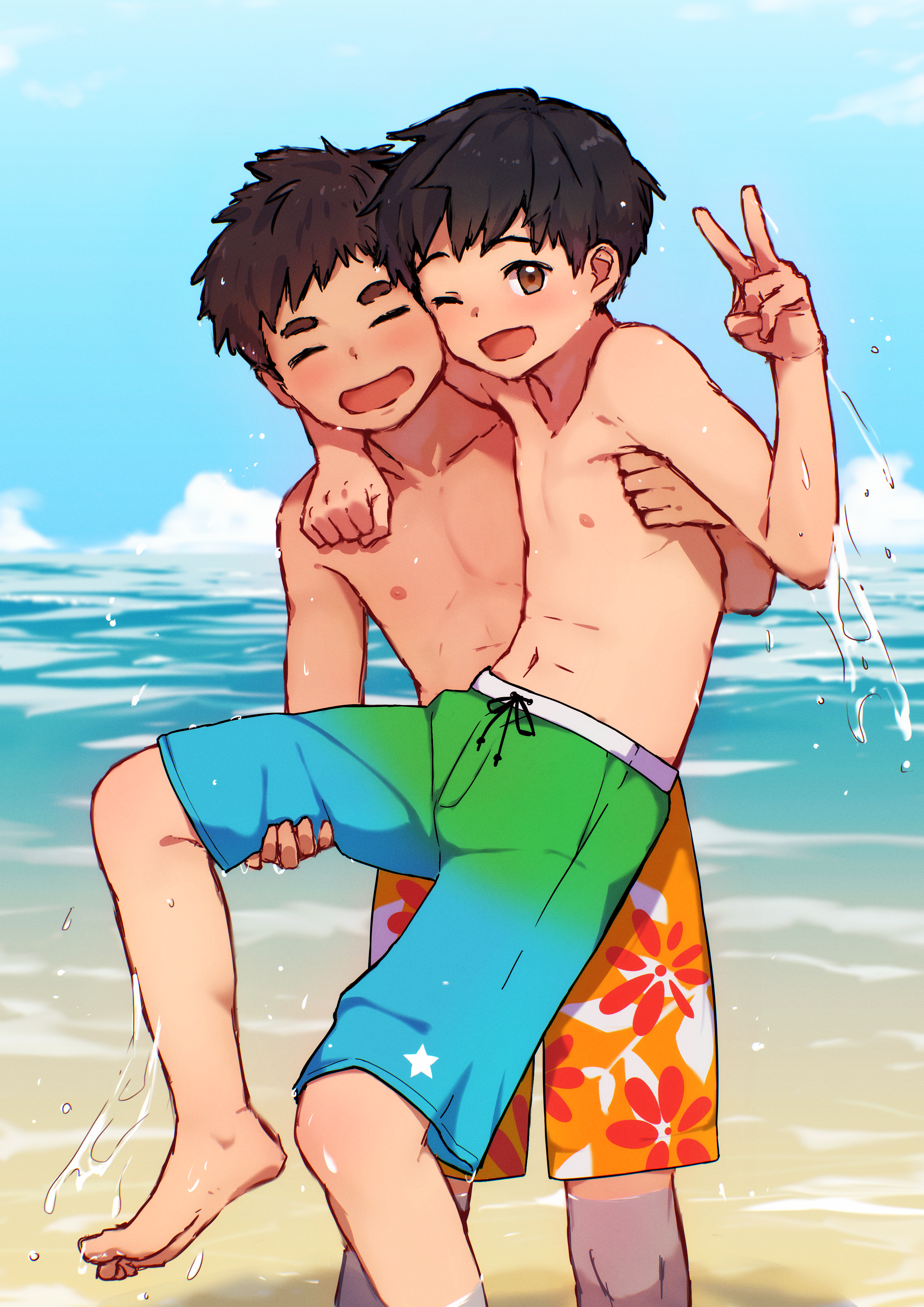 Ryo playing in the sea wearing green and blue swimtrunks